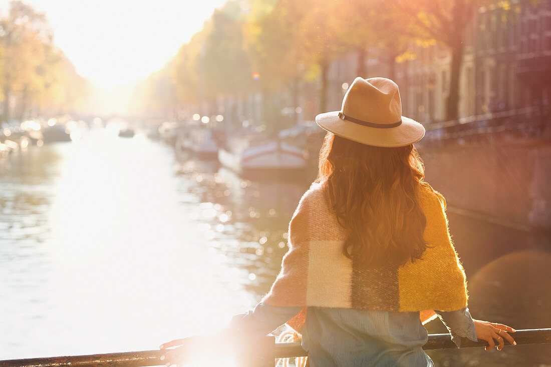 Woman looking at autumn canal view