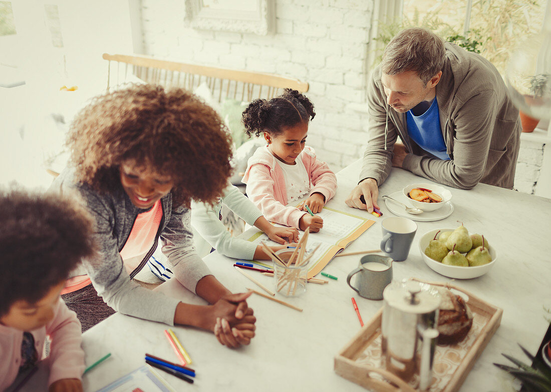 Family colouring with markers at table