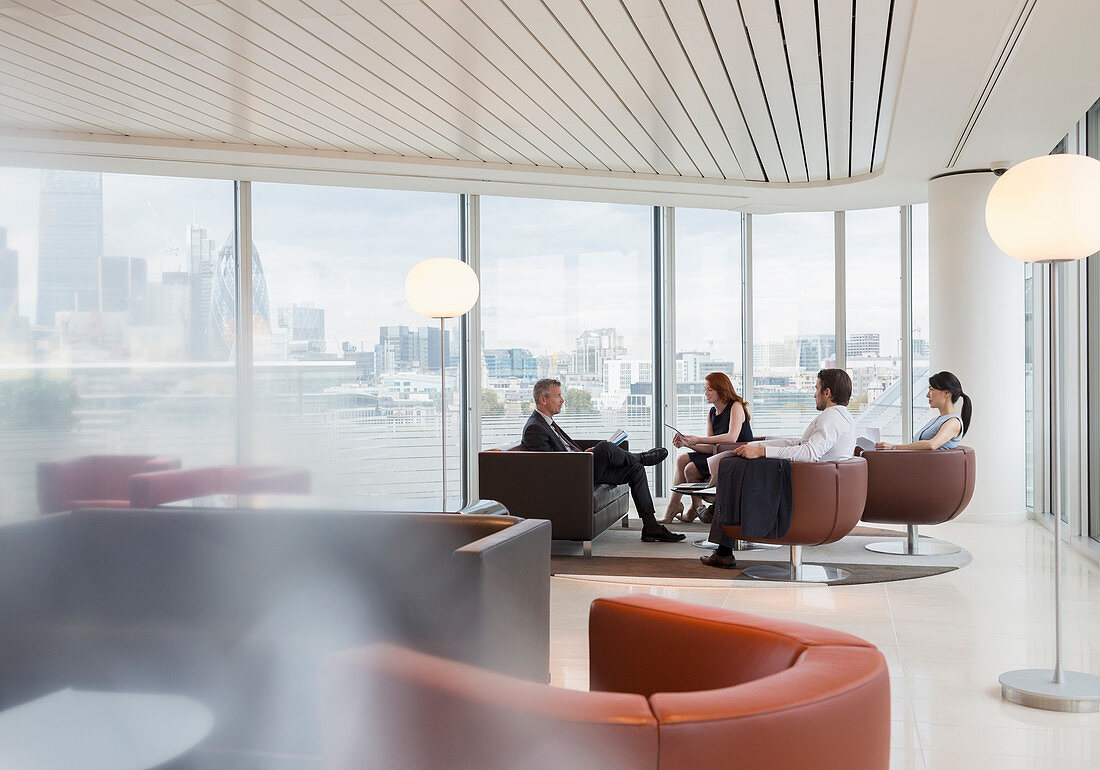 Business people meeting in high-rise office lounge