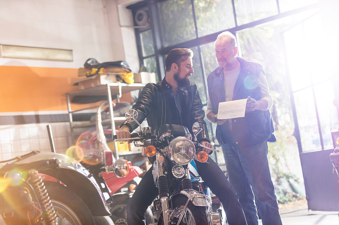 Motorcycle mechanic and customer talking