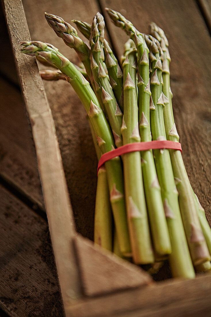Fresh asparagus bunch in wood crate