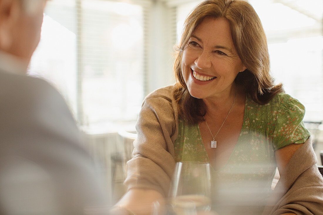 Smiling mature woman enjoying date, dining