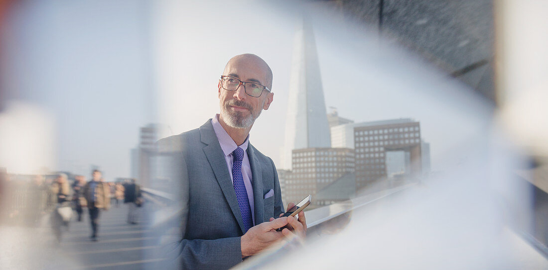 Pensive businessman with tablet, London, UK