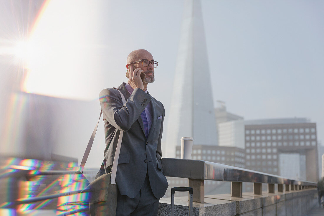 Businessman talking on cell phone, London, UK