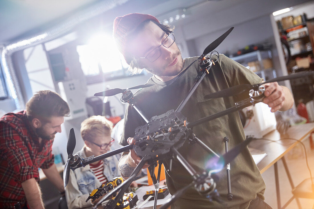 Male designer assembling drone in workshop