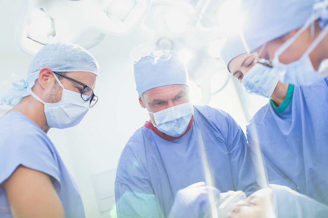 Surgeons and anaesthesiologist preparing patient