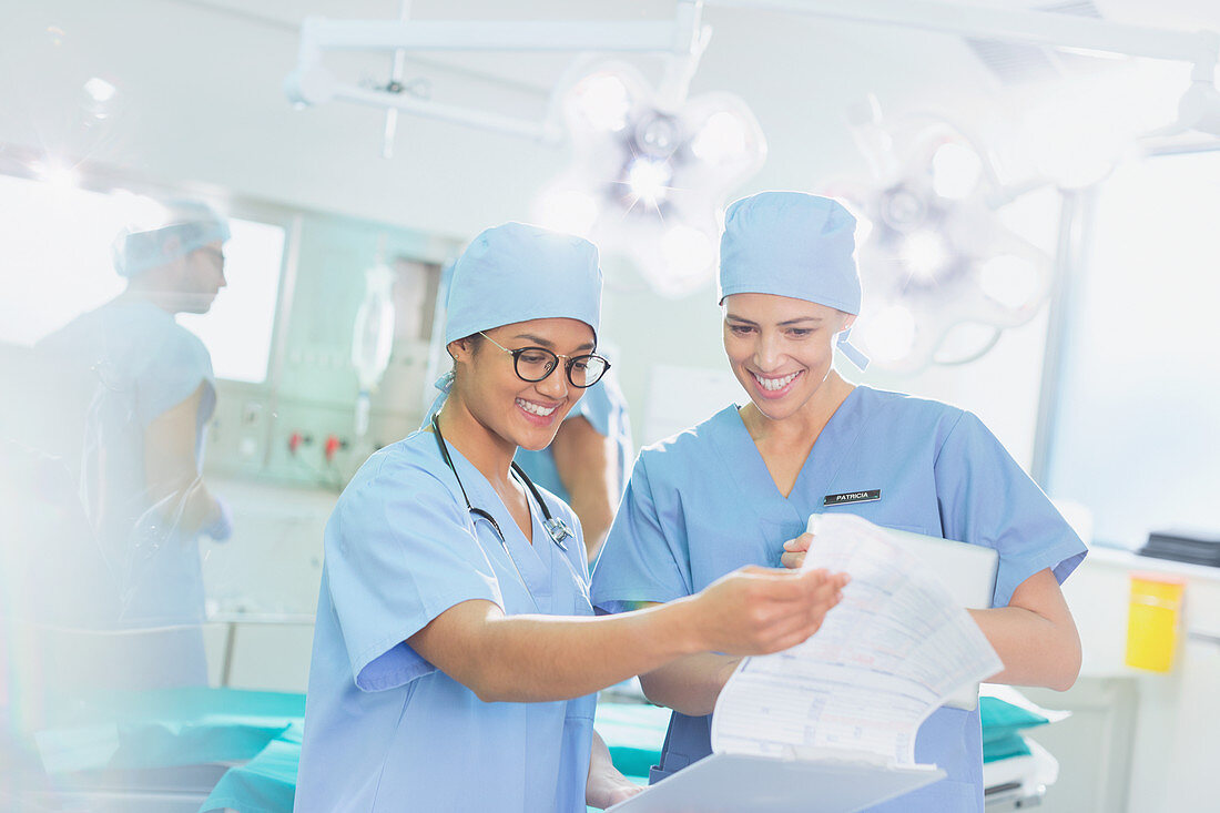 Female surgeons reviewing paperwork