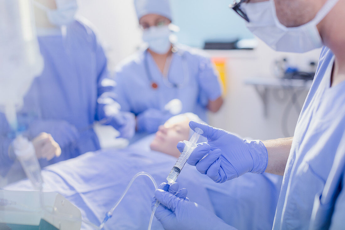 Anaesthesiologist injecting anaesthesia