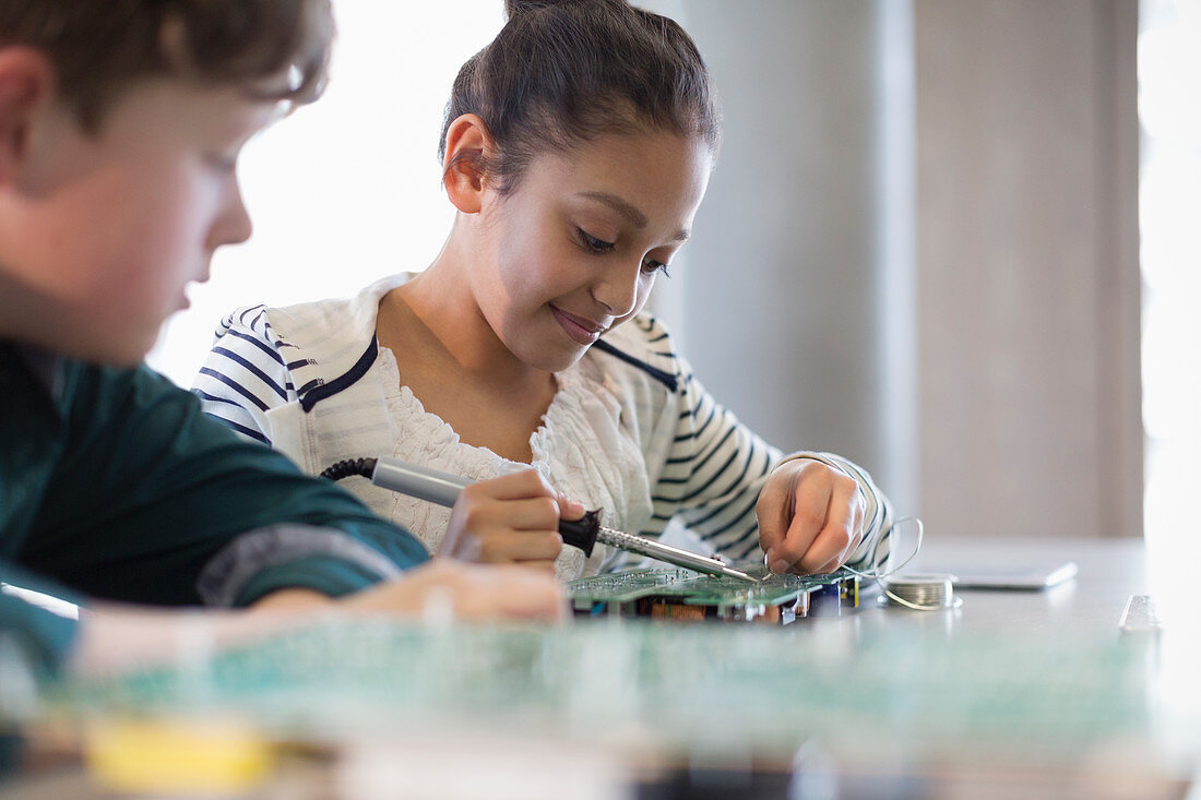 Students soldering circuit board