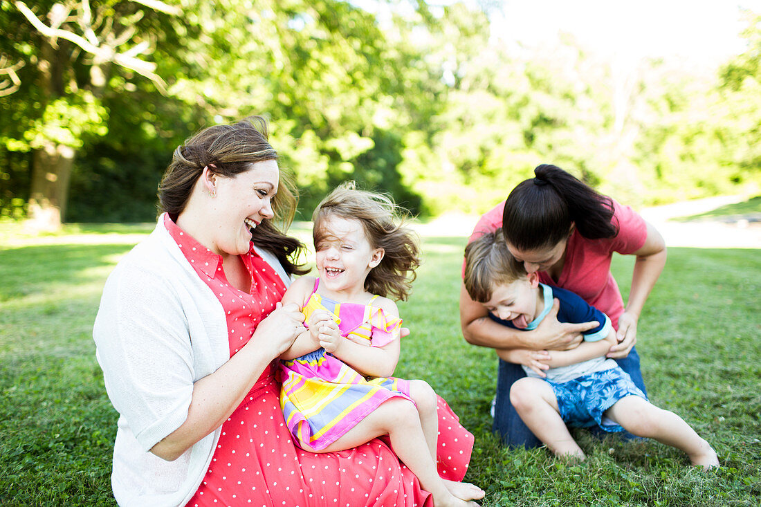 Lesbian mothers playing, tickling children