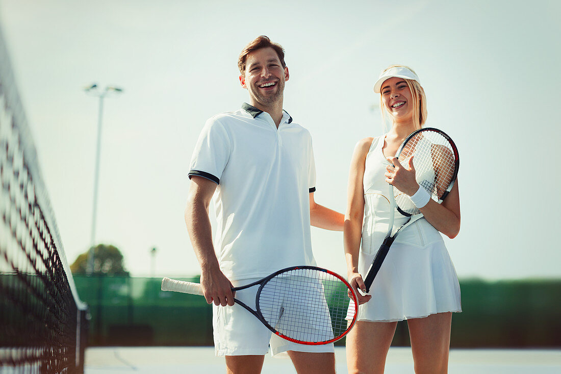 Portrait tennis players holding tennis rackets