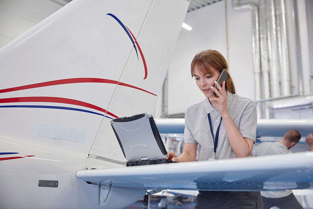 Female airplane engineer working at laptop