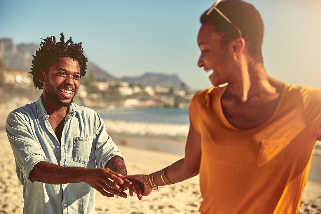 Playful young couple holding hands