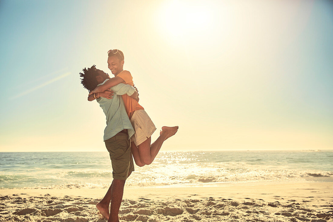 Playful boyfriend lifting girlfriend