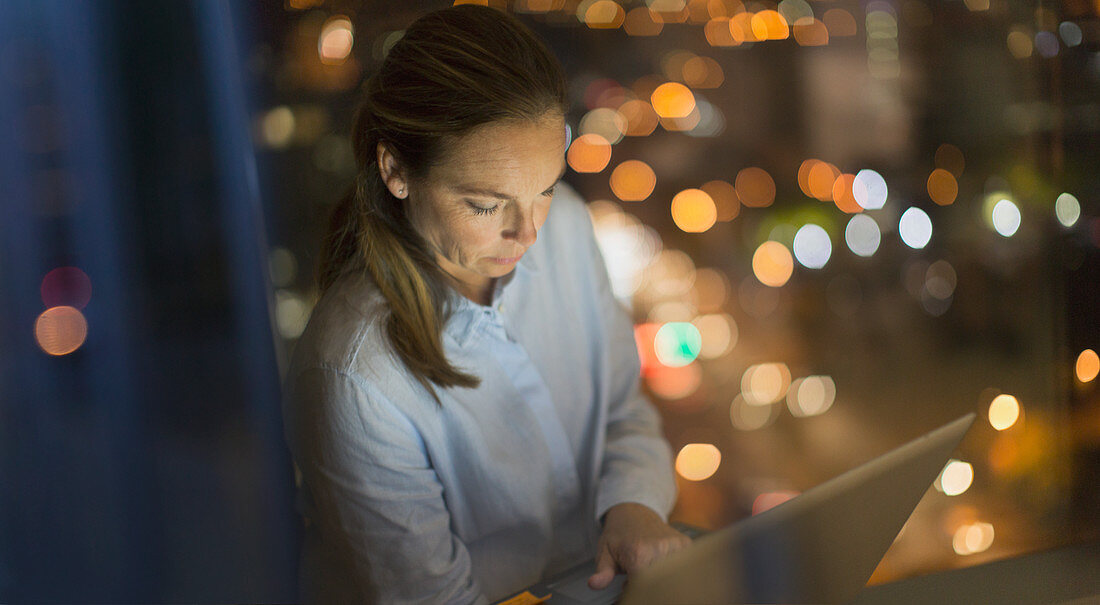 Businesswoman working late at laptop