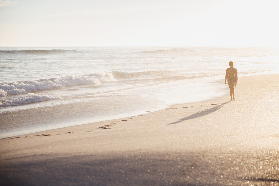 Silhouette woman walking on beach