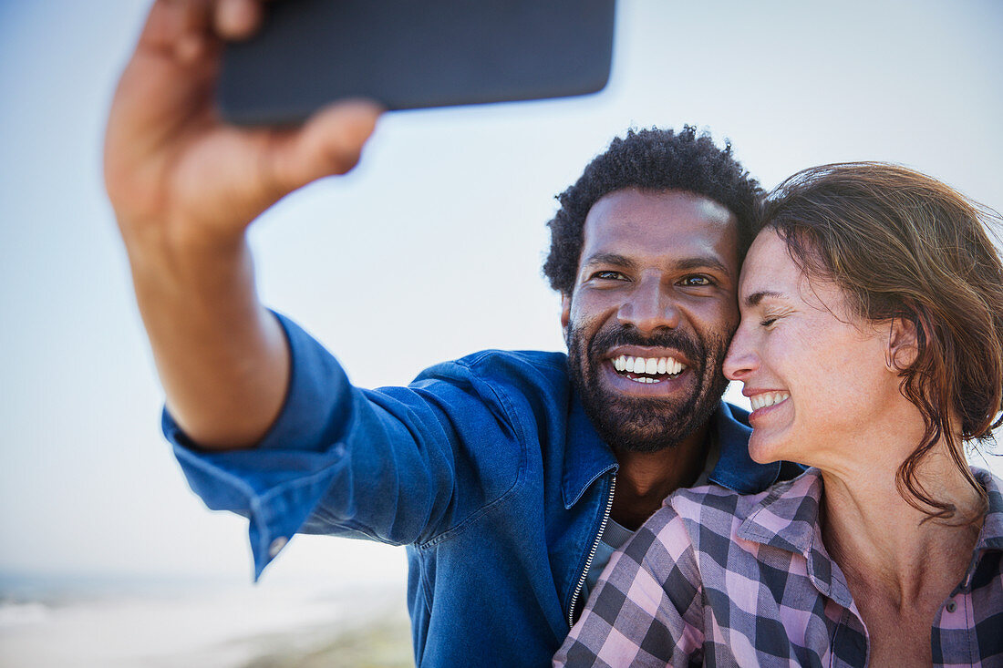 Affectionate, happy couple taking selfie