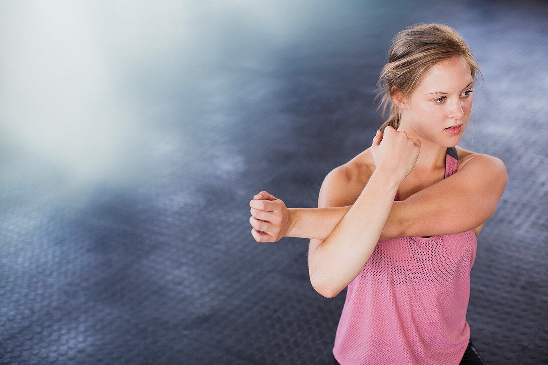 Young woman stretching arm and shoulder