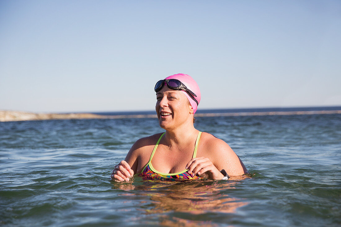 Smiling female swimmer swimming