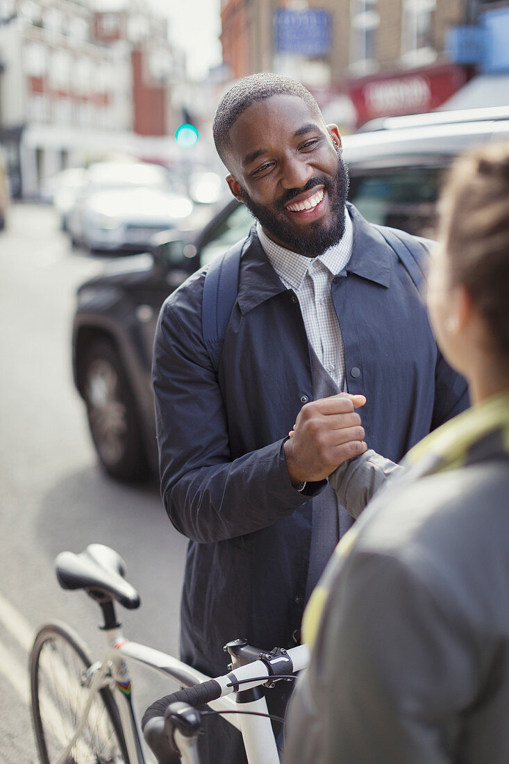 Smiling businessman with bicycle shaking hands