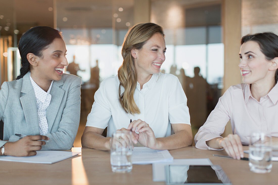 Smiling businesswomen talk