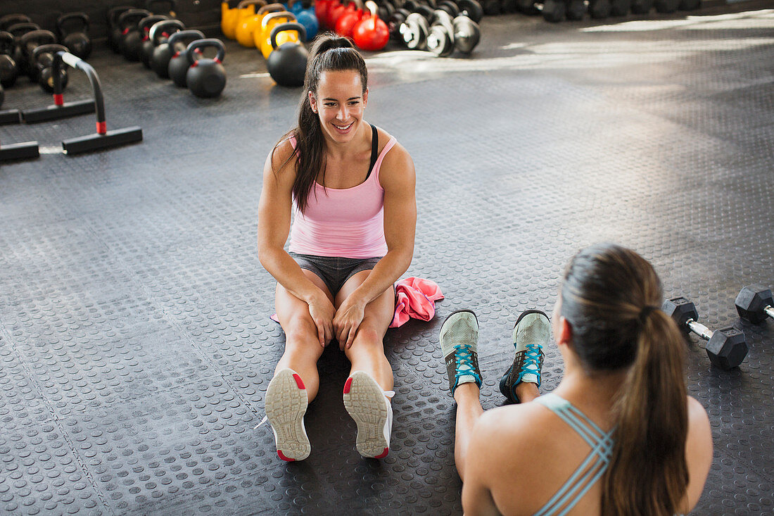 Young women talking and stretching legs