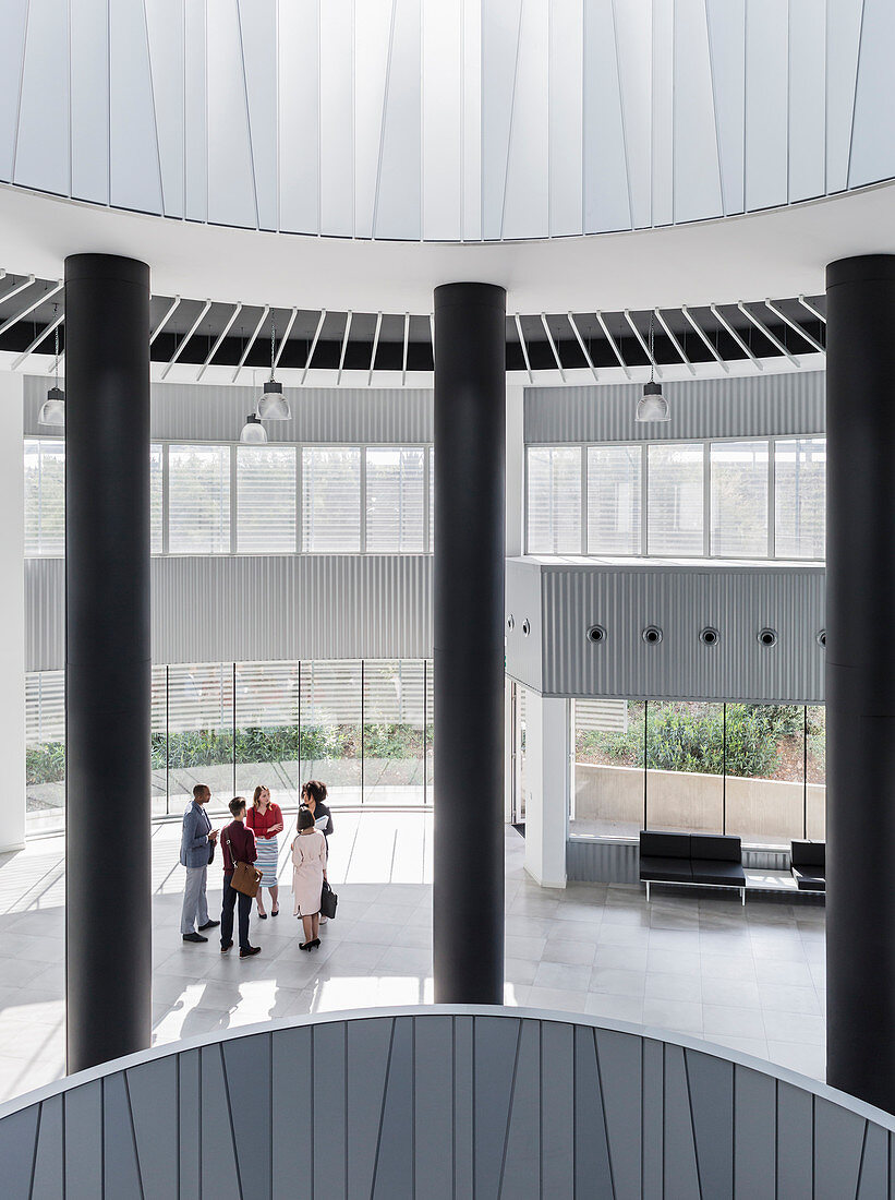 Business people talking in modern office atrium