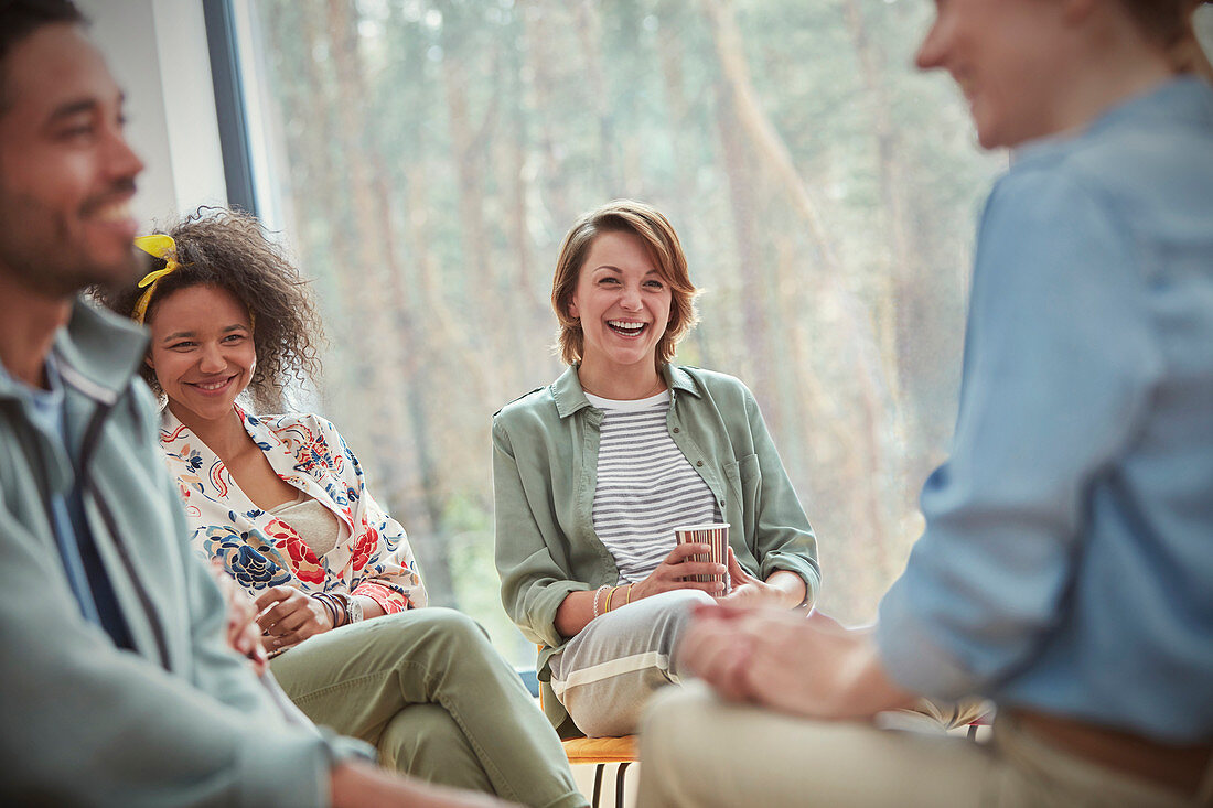 People and laughing in group therapy session