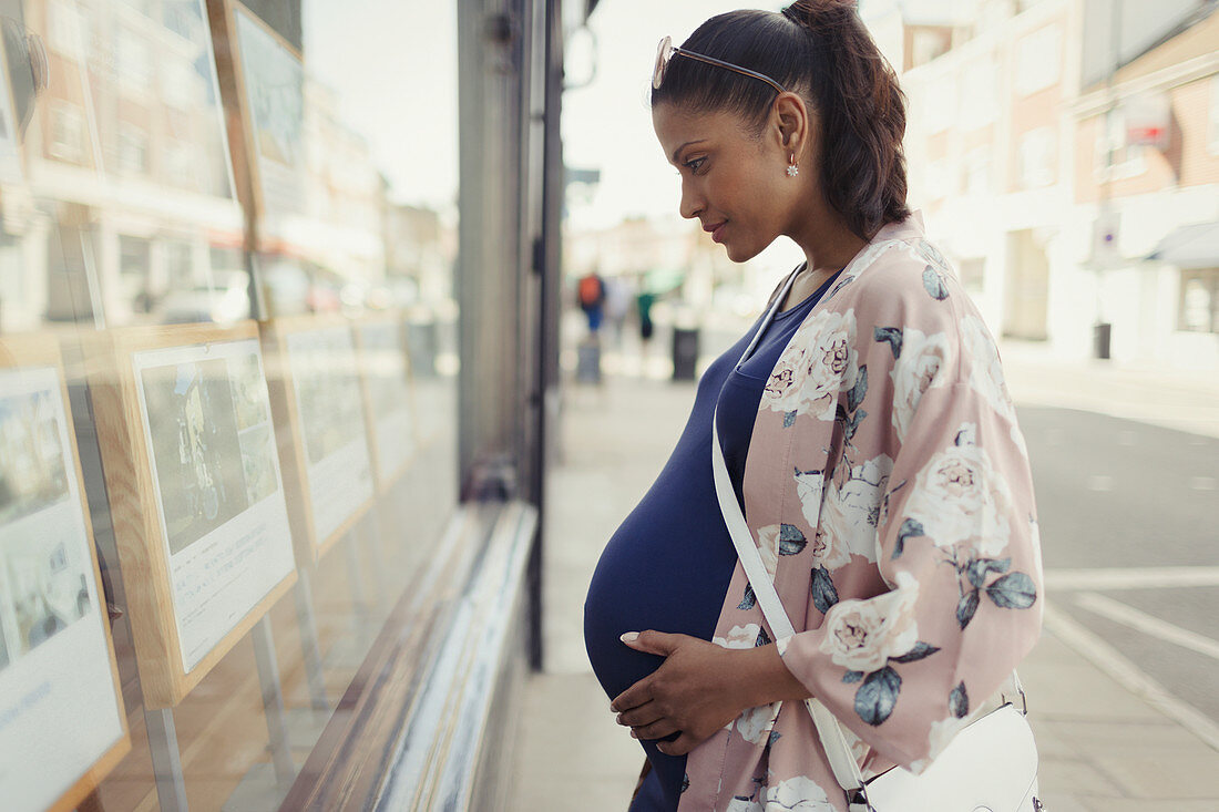 Pregnant woman browsing real estate listings