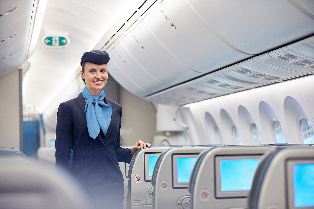Portrait female flight attendant on airplane