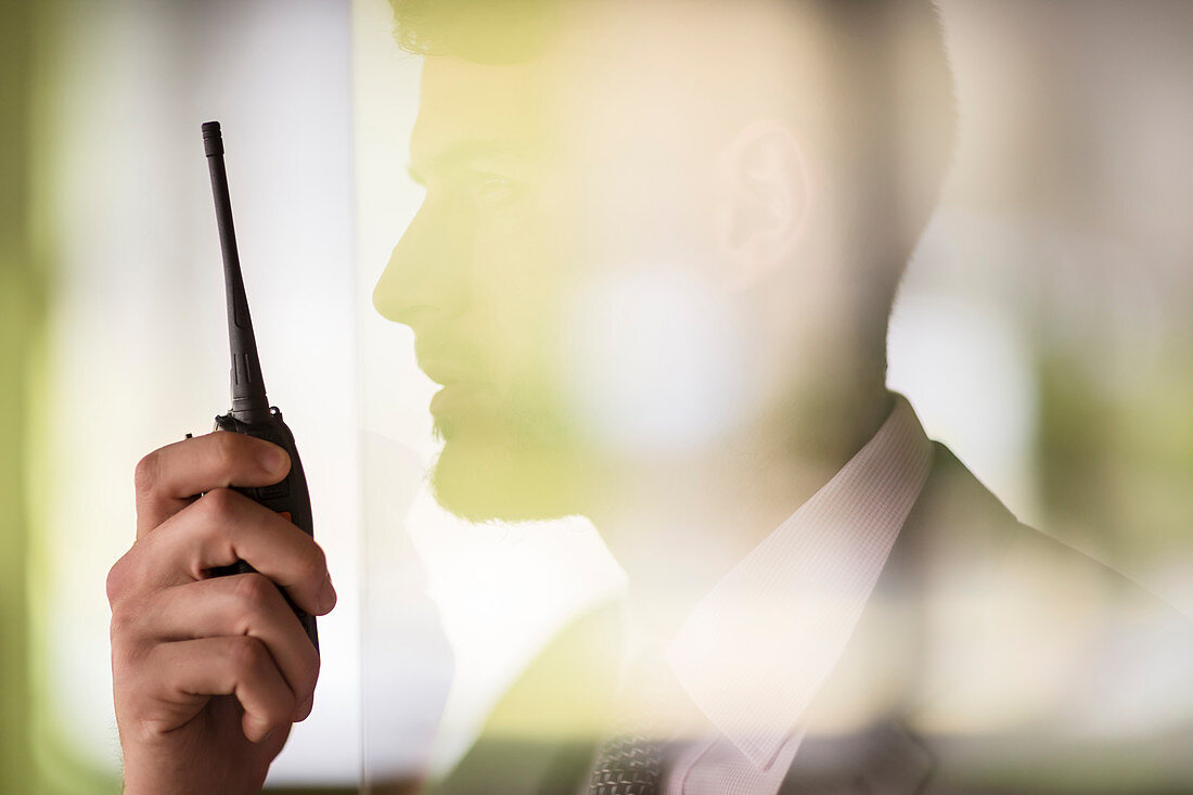 Close up businessman using walkie-talkie