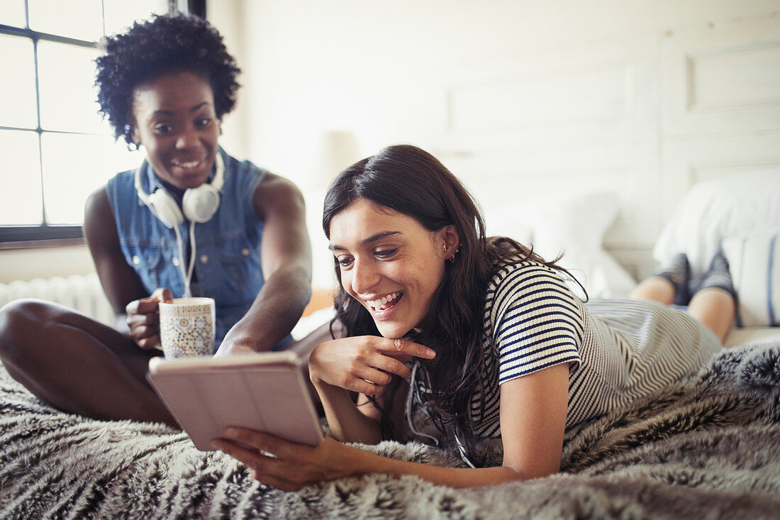 Smiling women using tablet