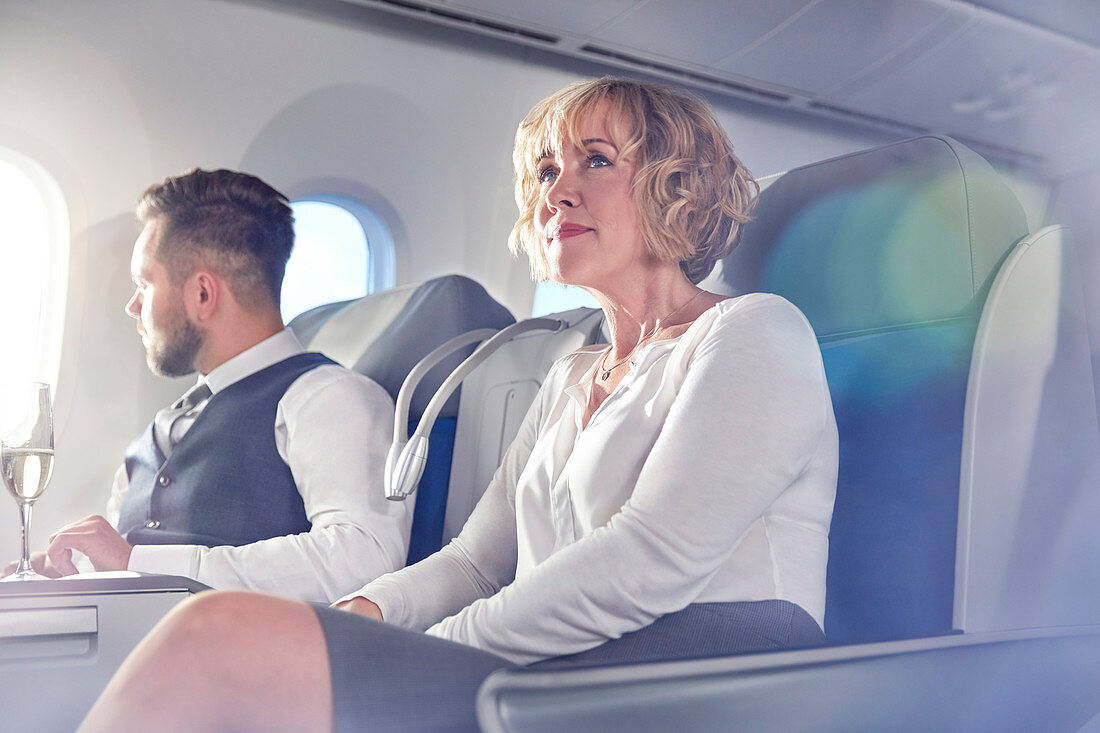 Businesswoman sitting in first class on airplane