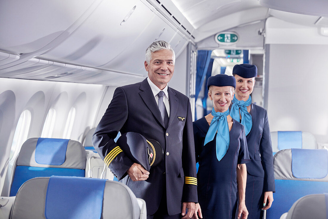 Portrait confident pilot and flight attendants