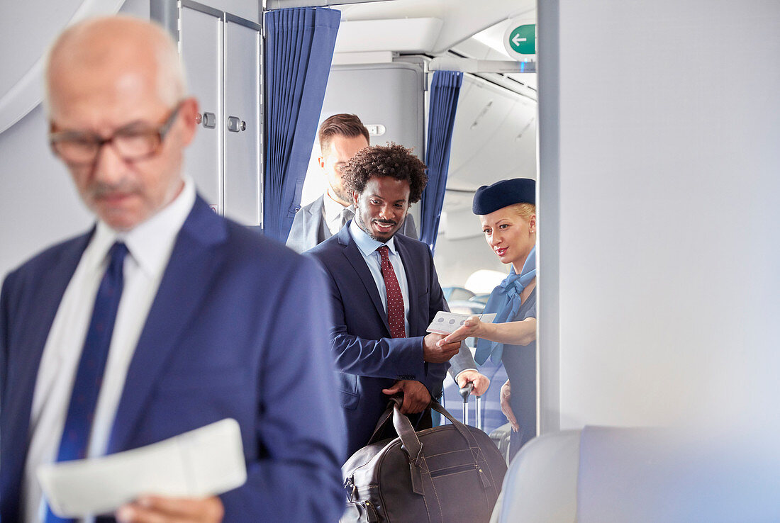 Flight attendant helping businessman