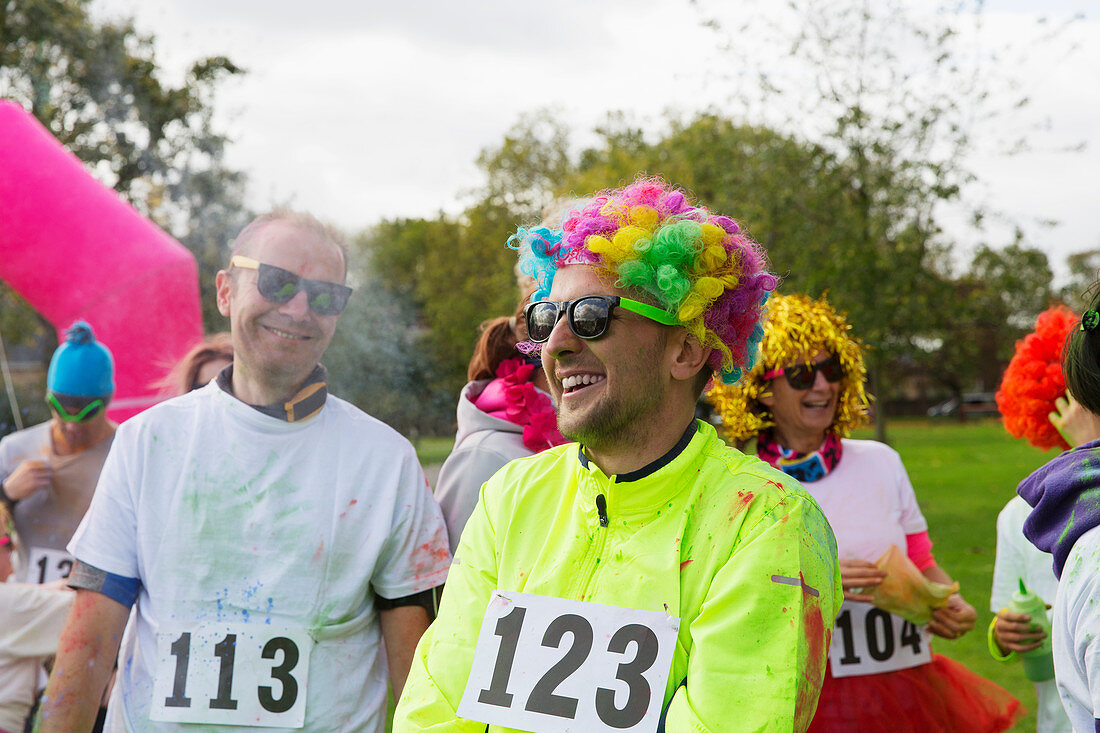 Playful runner in wig at charity run in park