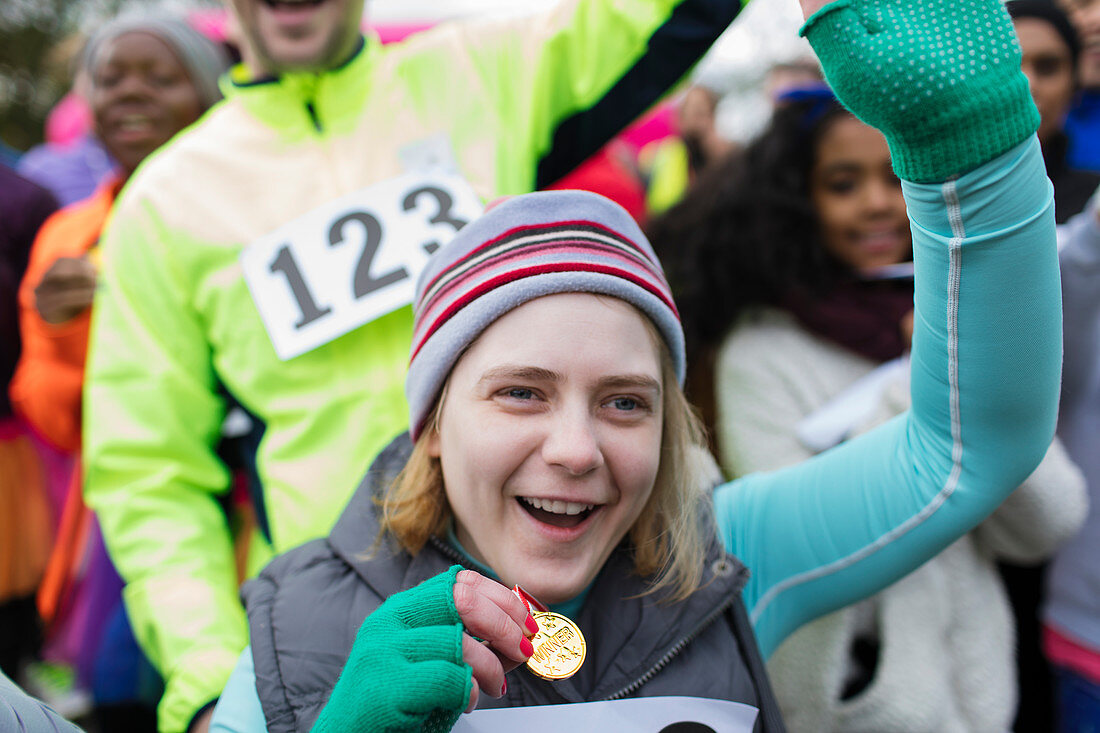 Enthusiastic woman with medal cheering