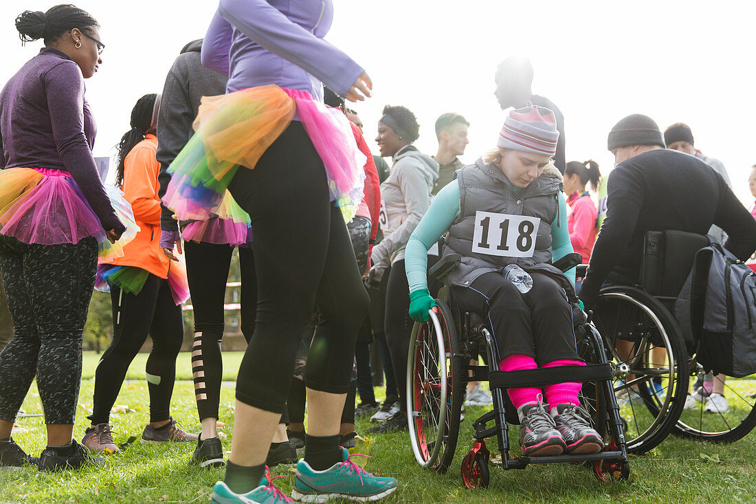 Woman in wheelchair at charity race in park