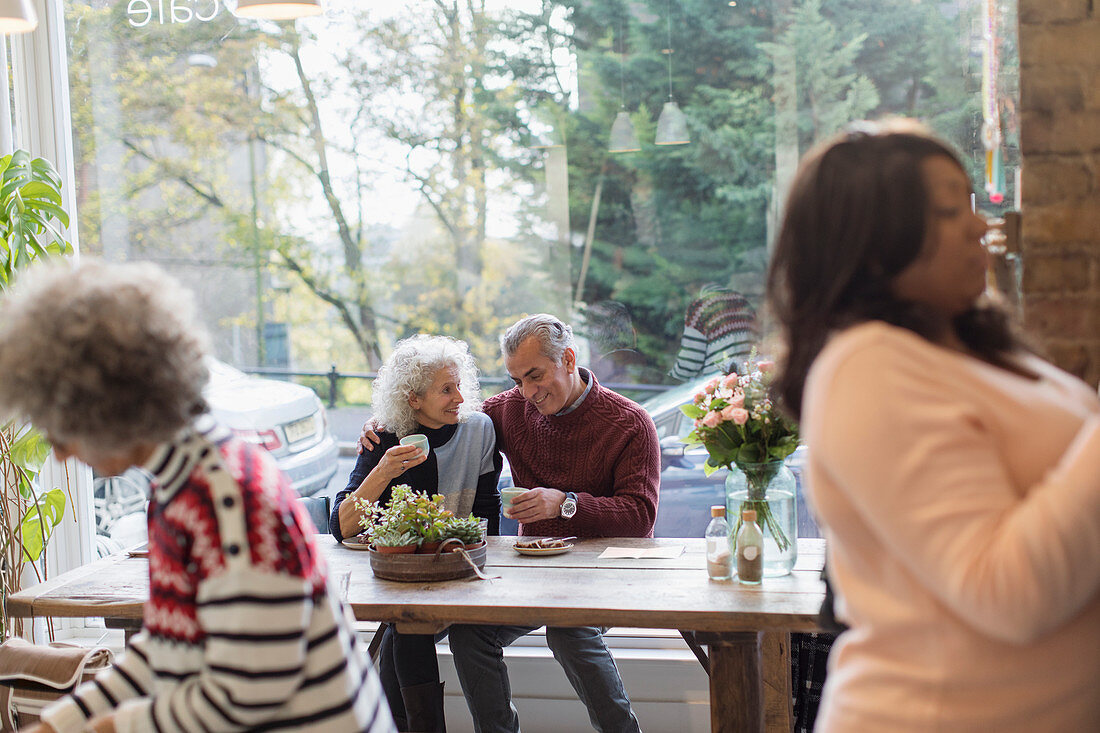 Affectionate couple drinking tea window