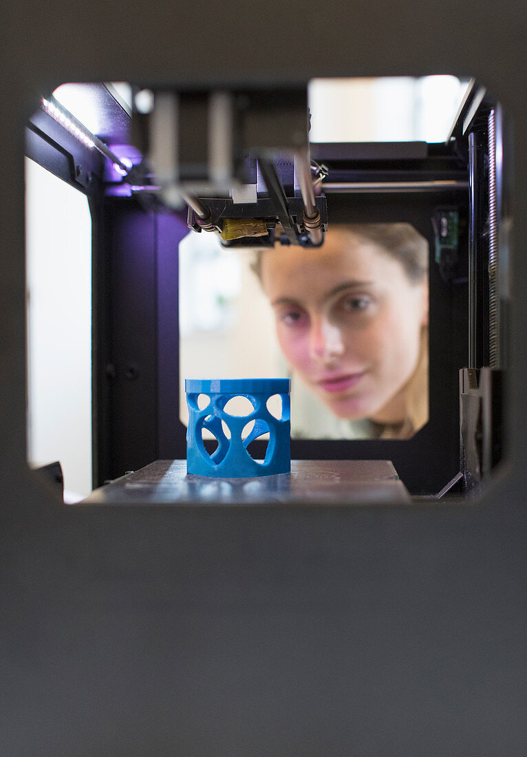 Female designer using 3D printer