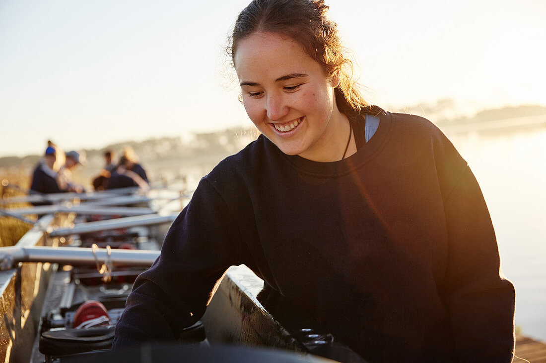 Smiling female rower preparing scull