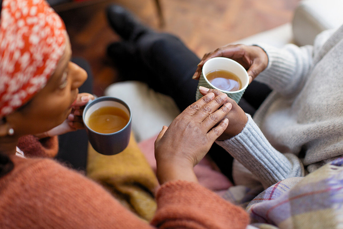 Women friends talking, drinking tea