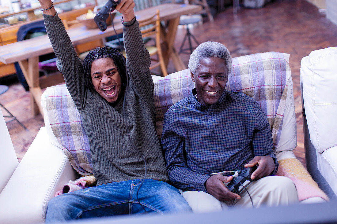 Grandfather and grandson playing video game