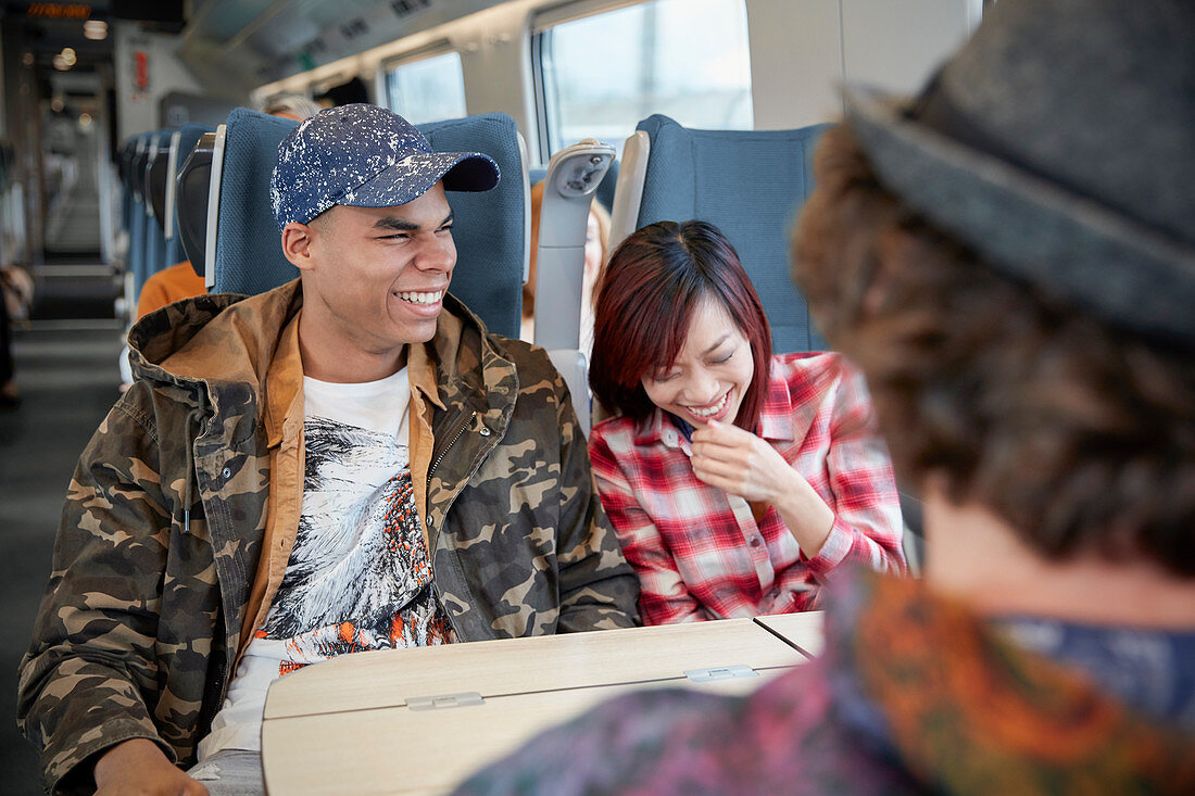 Young couple laughing on train