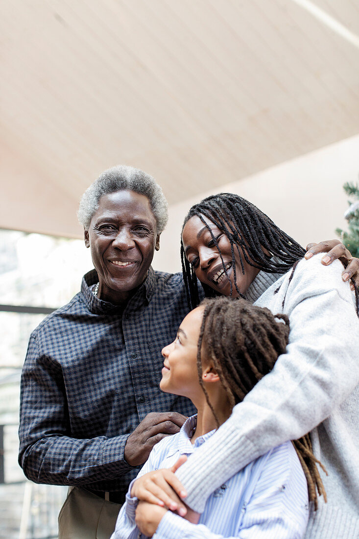 Portrait smiling multi-generation family hugging
