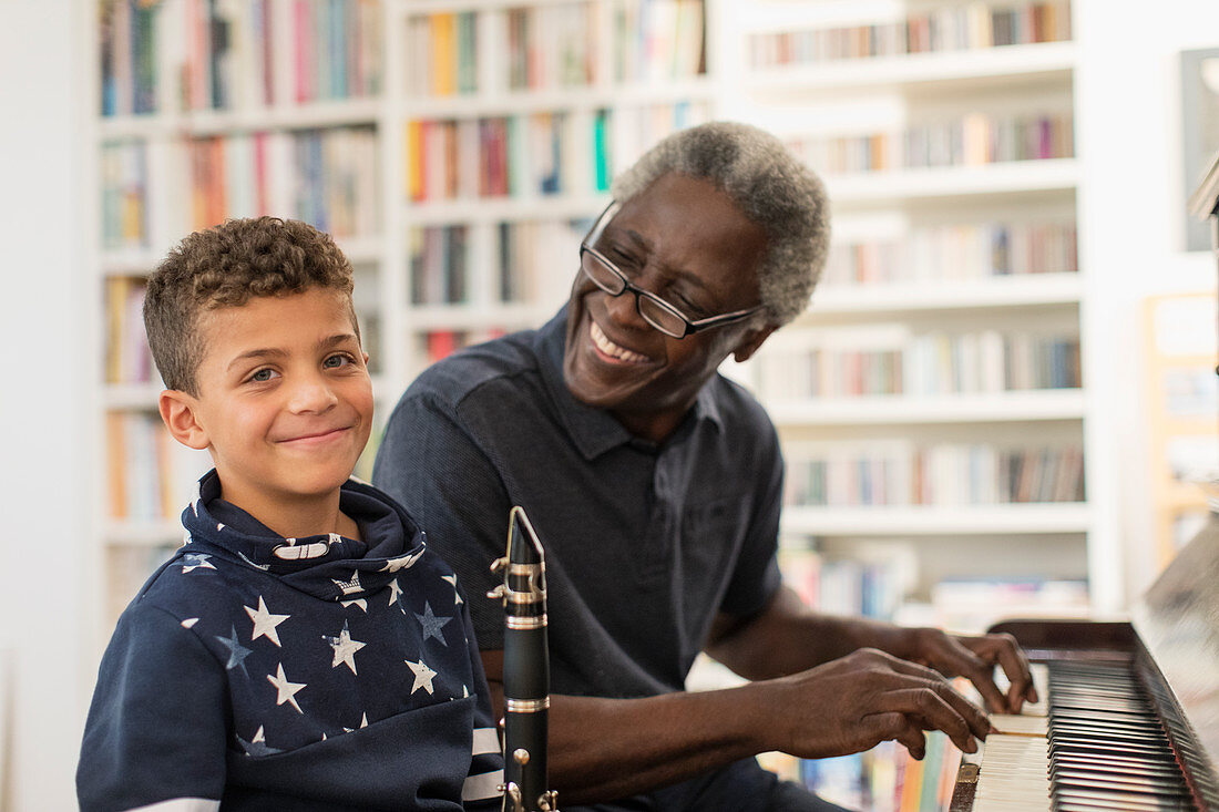 Grandfather and grandson playing piano and clarinet