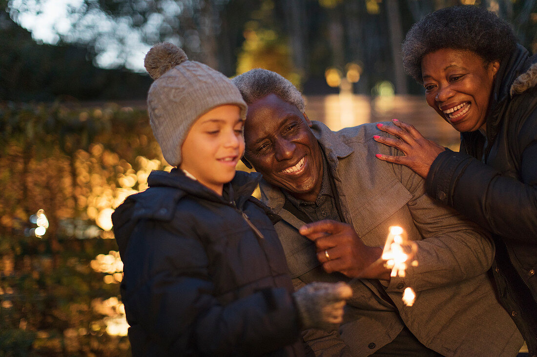 Family playing with firework sparkler