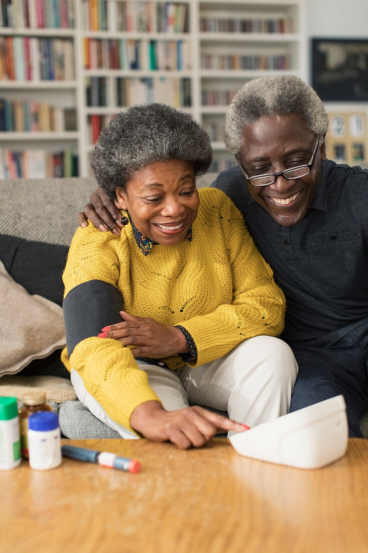 Senior couple checking blood pressure