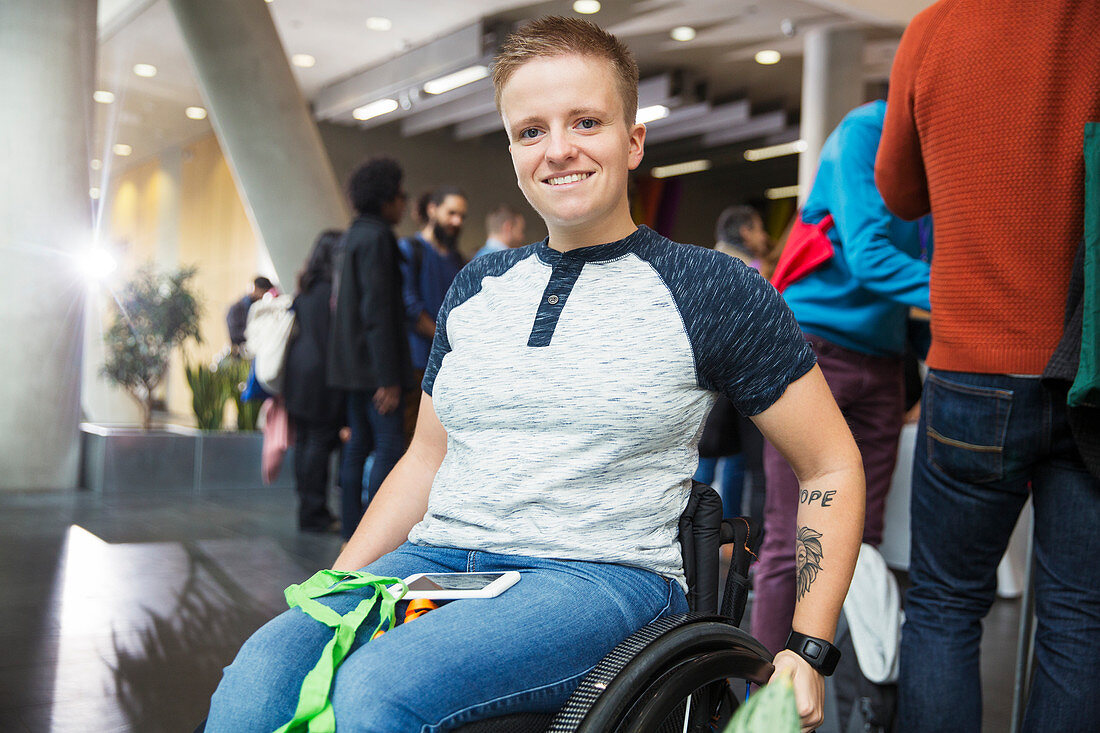 Young woman in wheelchair at conference