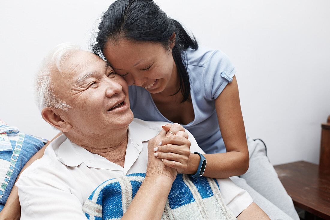 Senior father and daughter hugging